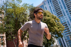 Runner on a city street between glass towers wearing camera glasses