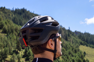 Cyclist paused at a mountain pass looking out over the valley